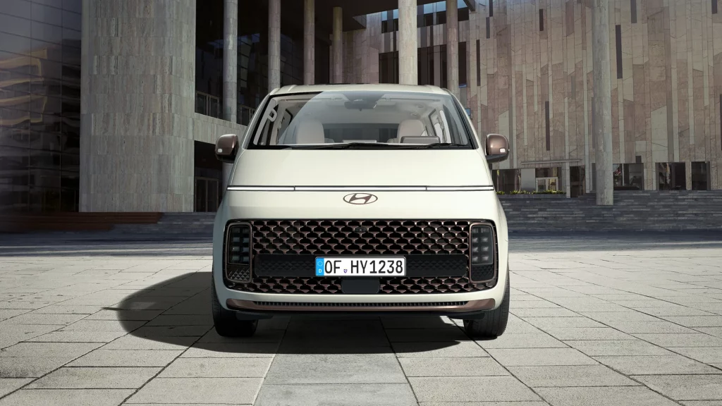 Modern compact city car with sleek design and urban architecture backdrop.