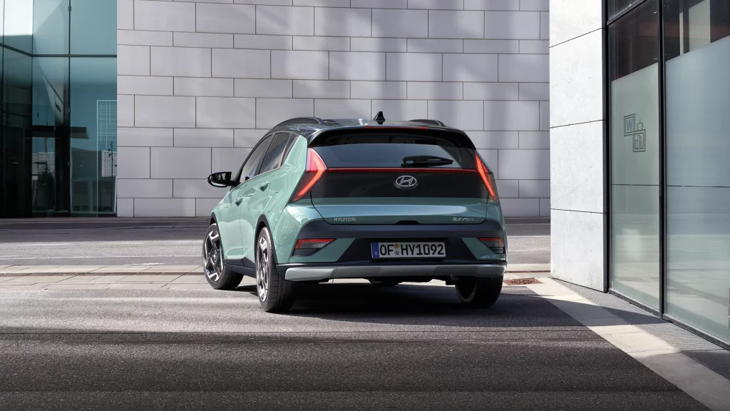 Modern green urban hatchback with sporty design reflecting sustainable, innovative city mobility.