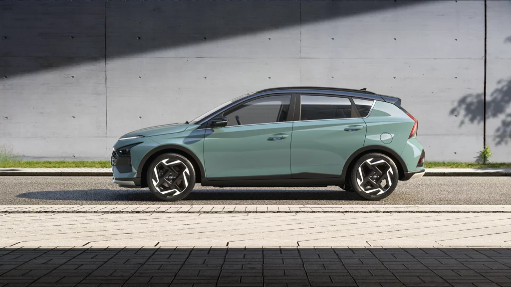 Sleek mint green urban SUV with black accents and large alloy wheels against concrete background.