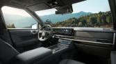 Innenraum eines modernen schwarzen Hyundai SUV mit digitalem Cockpit vor Berglandschaft