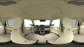 Heller, moderner Innenraum eines kompakten Wagens mit beige Stoffpolstern und großem Panorama-Glasdach