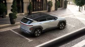 Silver Hyundai Kona SUV in upscale city street with modern design and urban elegance.