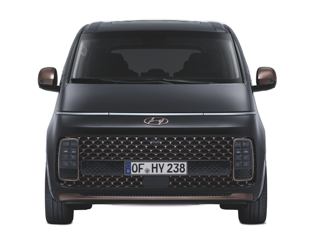 Mattschwarzer Hyundai Van frontal mit markantem Grill und bronzenen Akzenten vor neutralem Hintergrund