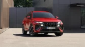 Roter Hyundai Kompakt-SUV frontal vor modernem urbanem Gebäude bei Tageslicht geparkt